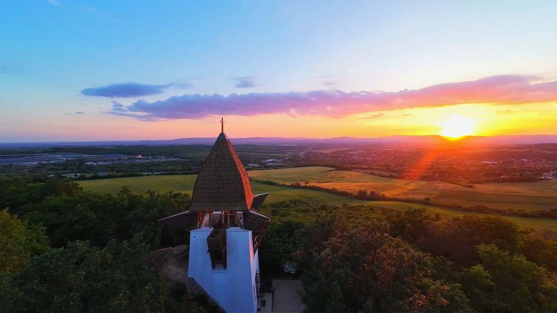 Aerial shot of a lookout tower at sunset